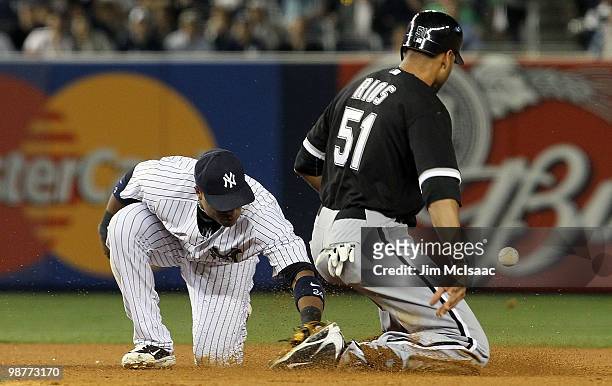 Robinson Cano of the New York Yankees can not come up with the ball as Alex Rios of the Chicago White Sox steals second base in the seventh inning on...