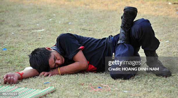 Thai Red Shirt anti-government protester sleeps on the ground inside the Red Shirts' fortified camp in the financial central district of Silom in...