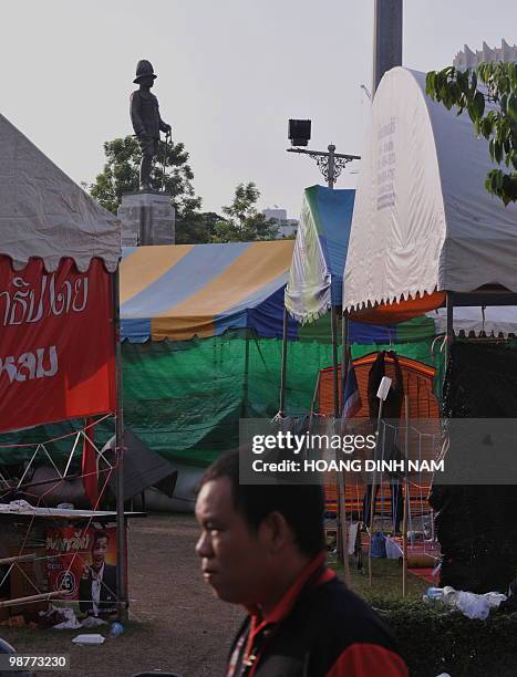 The statue of King Rama IV looms over tents of Thai Red Shirt anti-government protesters inside their fortified camp in the financial central...