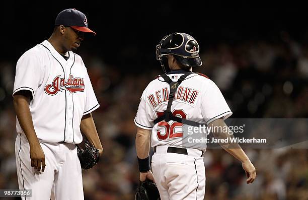 Fausto Carmona of the Cleveland Indians talks at the mound with Mike Redmond during the game against the Minnesota Twins on April 30, 2010 at...