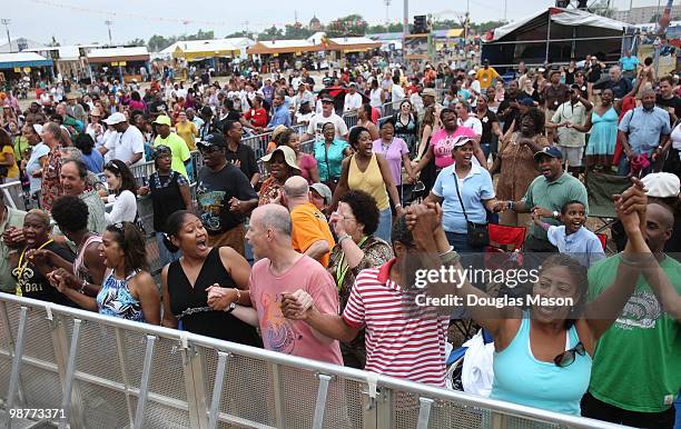 Fans look on as Kirk Franklin performs at the 2010 New Orleans Jazz & Heritage Festival Presented By Shell, at the Fair Grounds Race Course on April...