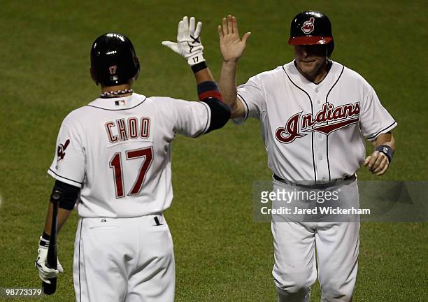 Mike Redmond is congratulated by Shin-Soo Choo of the Cleveland Indians after scoring against the Minnesota Twins during the game on April 30, 2010...