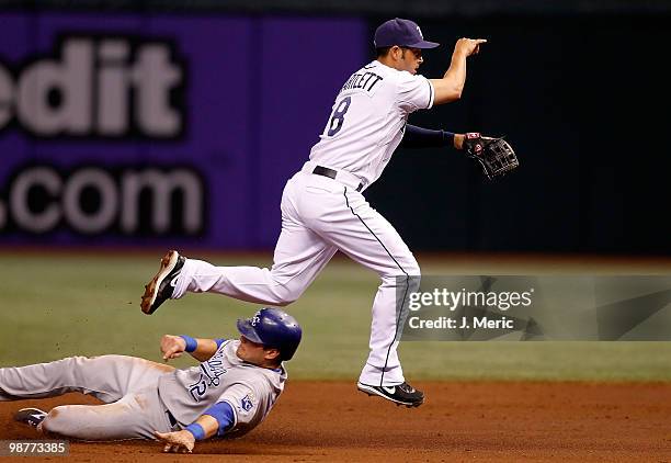 Shortstop Jason Bartlett of the Tampa Bay Rays turns a double play as Mitch Maier of the Kansas City Royals attempts to break it up during the game...