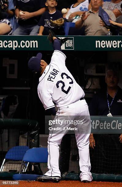 Carlos Pena of the Tampa Bay Rays fell into the dugout after catching this pop foul against the Kansas City Royals at Tropicana Field on April 30,...