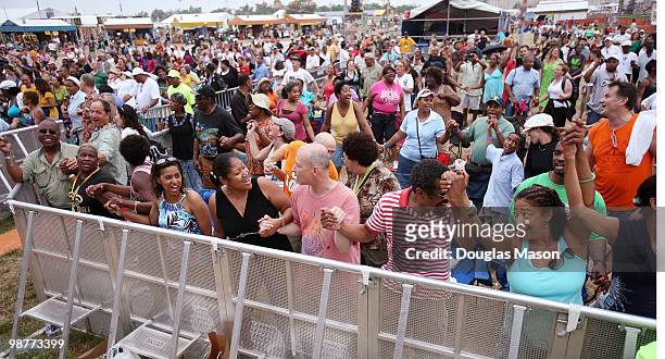 Fans look on as Kirk Franklin performs at the 2010 New Orleans Jazz & Heritage Festival Presented By Shell, at the Fair Grounds Race Course on April...