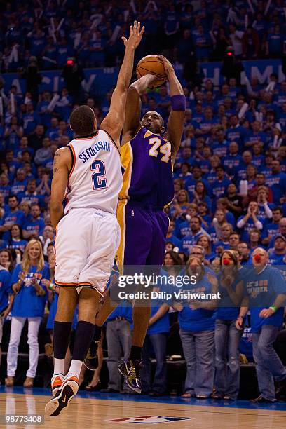 Kobe Bryant of the Los Angeles Lakers shoots the ball against Thabo Sefolosha of the Oklahoma City Thunder during Game Six of the Western Conference...