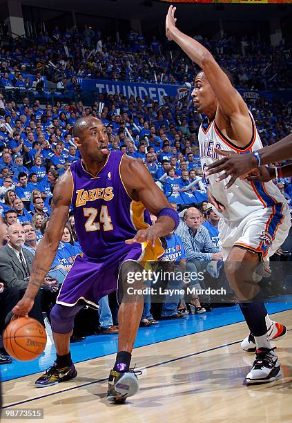 Kobe Bryant of the Los Angeles Lakers drives to the basket against Thabo Sefolosha of the Oklahoma City Thunder in Game Six of the Western Conference...