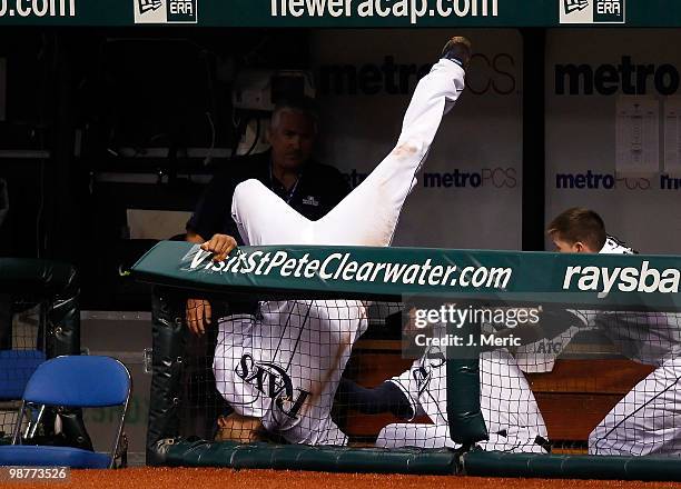 First baseman Carlos Pena of the Tampa Bay Rays falls into the dugout after catching a foul ball against the Kansas City Royals during the game at...