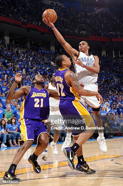 Russell Westbrook of the Oklahoma City Thunder goes hard to the hoop against Josh Powell and Shannon Brown of the Los Angeles Lakers in Game Six of...