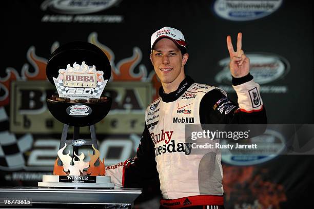 Brad Keselowski, driver of the Ruby Tuesday Dodge, celebrates with the race trophy in victory lane after winning the NASCAR Nationwide Series BUBBA...