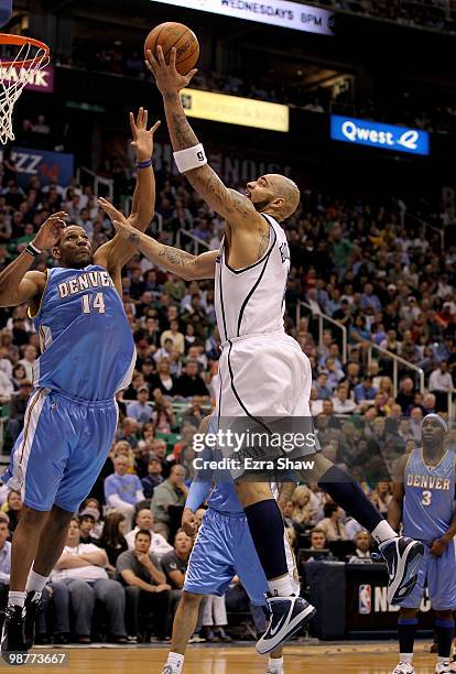 Carlos Boozer of the Utah Jazz goes up for a shot over Joey Graham of the Denver Nuggets during Game Six of the Western Conference Quarterfinals of...