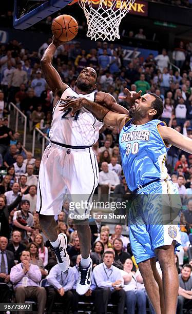 Paul Millsap of the Utah Jazz dunks over Malik Allen of the Denver Nuggets during Game Six of the Western Conference Quarterfinals of the 2010 NBA...