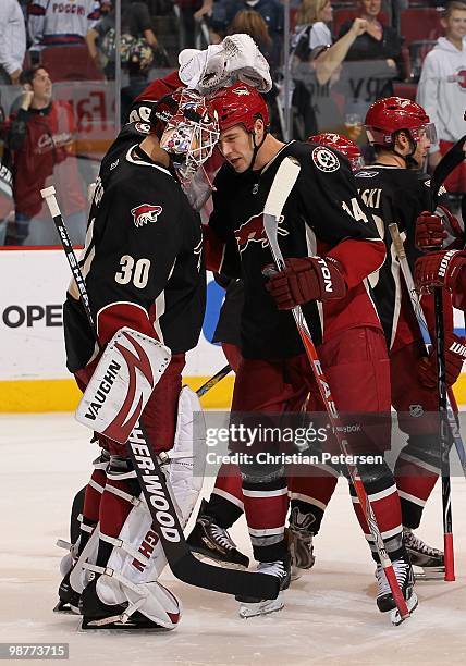Goaltender Ilya Bryzgalov and Taylor Pyatt of the Phoenix Coyotes celebrate after the NHL game against the Edmonton Oilers at Jobing.com Arena on...