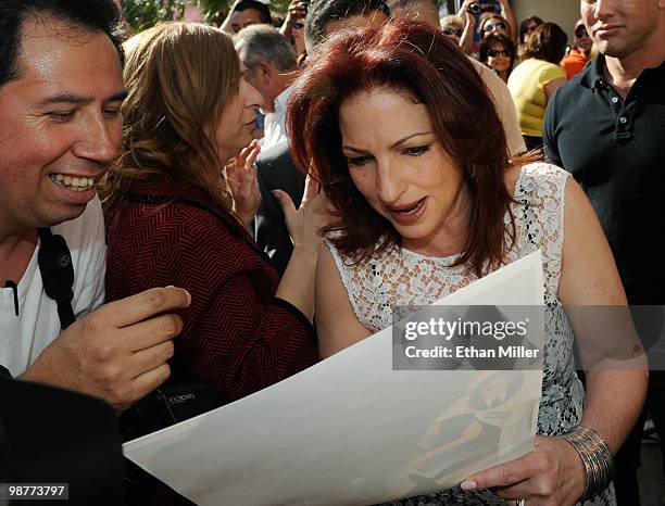 Singer Gloria Estefan signs autographs for fans outside the Flamingo Las Vegas during the Las Vegas Walk of Stars unveiling ceremony for her and her...