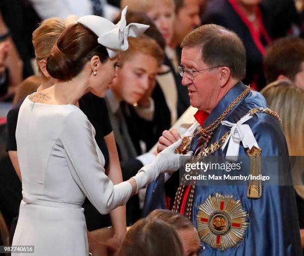 Angelina Jolie, an Honorary Dame Commander of The Most Distinguished Order of Saint Michael and Saint George, greets Lord George Robertson as she...