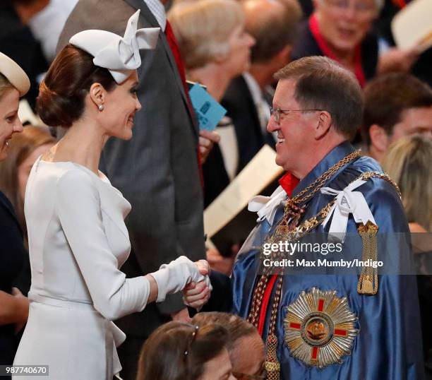 Angelina Jolie, an Honorary Dame Commander of The Most Distinguished Order of Saint Michael and Saint George, greets Lord George Robertson as she...