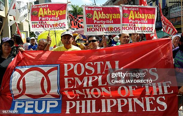 Union members turn a Labour Day march into an election rally in Manila on May 1, 2010 as they wore yellow, the campaign colour of leading...