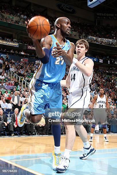 Johan Petro of the Denver Nuggets passes the ball around Kyrylo Fesenko of the Utah Jazz in Game Six of the Western Conference Quarterfinals during...