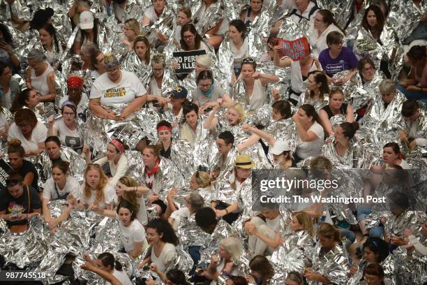 Large group of mostly women demonstrators, wrapped in emergency blankets, conduct a sit in inside the Hart Senate office building in Washington,...