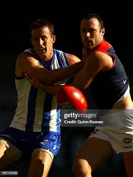 David Hale of the Kangaroos and Matthew Warnock of the Demons contest for the ball during the round six AFL match between the North Melbourne...