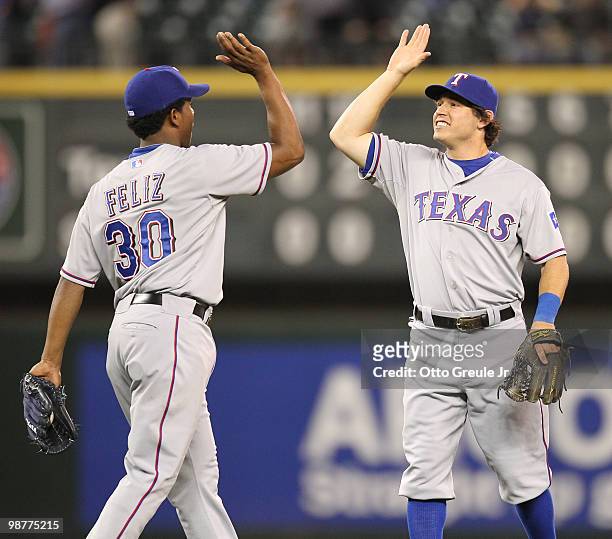 Ian Kinsler and Neftali Feliz of the Texas Rangers celebrate after defeating the Seattle Mariners 2-0 in twelve innings at Safeco Field on April 30,...