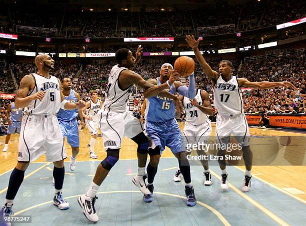 Carmelo Anthony of the Denver Nuggets is fouled by C.J. Miles of the Utah Jazz in Game Six of the Western Conference Quarterfinals of the 2010 NBA...