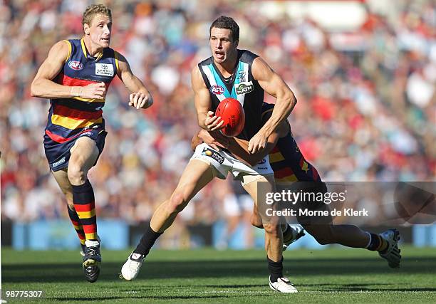 Brett Burton of the Crows chases after Travis Boak of the Power during the round six AFL match between the Adelaide Crows and the Port Adelaide Power...