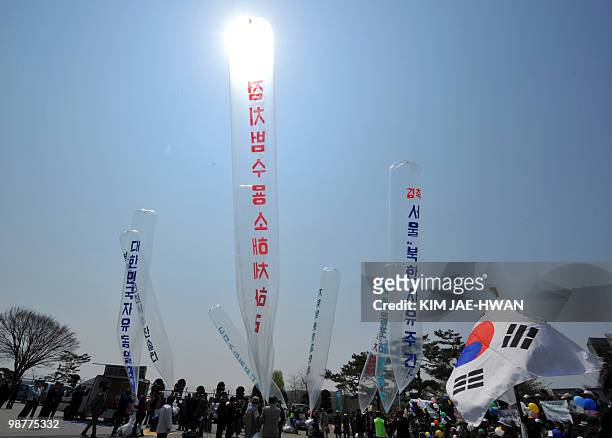South Korean activists prepare to float packs of leaflets using balloons into North Korea at Paju on May 1, 2010. The packs which contain DVDs, USD...