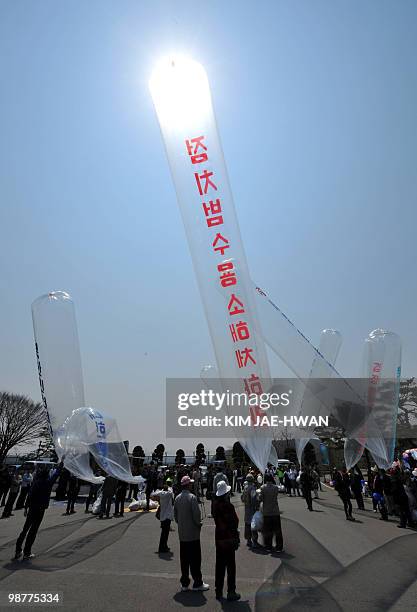 South Korean activists prepare to float packs of leaflets using balloons into North Korea at Paju on May 1, 2010. The packs which contain DVDs, USD...