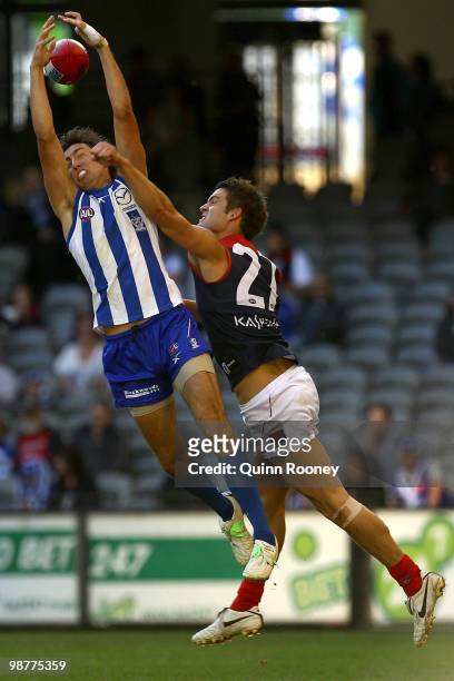 Sam Wright of the Kangaroos marks infront of Jared Rivers of the Demons during the round six AFL match between the North Melbourne Kangaroos and the...