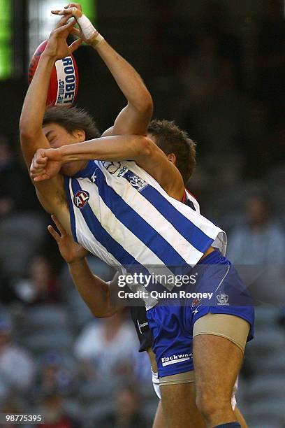 Sam Wright of the Kangaroos marks infront of Jared Rivers of the Demons during the round six AFL match between the North Melbourne Kangaroos and the...