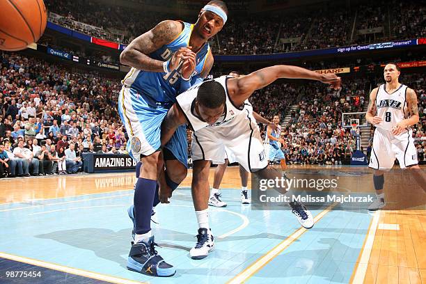 Miles of the Utah Jazz goes after a loose ball past Carmelo Anthony of the Denver Nuggets in Game Six of the Western Conference Quarterfinals during...