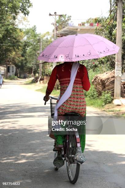 woman on bike - chitwan stock pictures, royalty-free photos & images