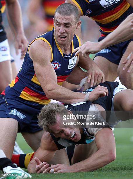 Simon Goodwin of the Crows lands on Brett Ebert of the Power during the round six AFL match between the Adelaide Crows and the Port Adelaide Power at...