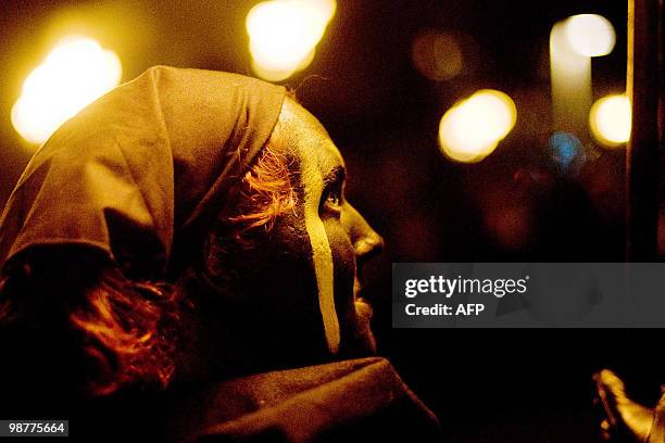 Woman looks on during the Beltane Fire Festival in Edinburgh, on April 30, 2010. The event, which celebrates an ancient Celtic festival, is a...