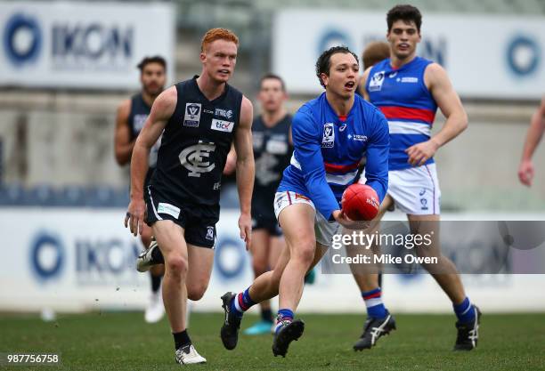 Alexander Greenwood of Footscray handballs during the round 13 VFL match between the Northern Blues and the Footscray Bulldogs at Ikon Park on June...