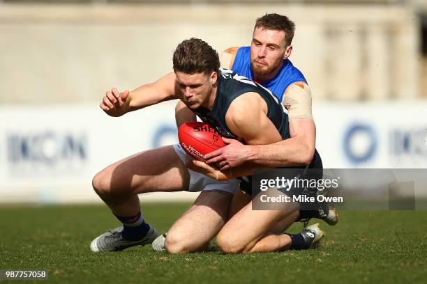 Kane Keppel of the Blues is tackled during the round 13 VFL match between the Northern Blues and the Footscray Bulldogs at Ikon Park on June 30, 2018...