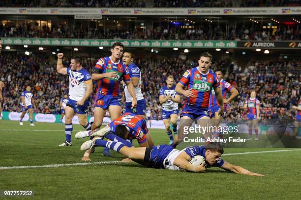 Kerrod Holland of the Bulldogs scores a try during the round 16 NRL match between the Newcastle Knights and the Canterbury Bulldogs at McDonald Jones...