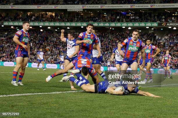 Kerrod Holland of the Bulldogs scores a try during the round 16 NRL match between the Newcastle Knights and the Canterbury Bulldogs at McDonald Jones...