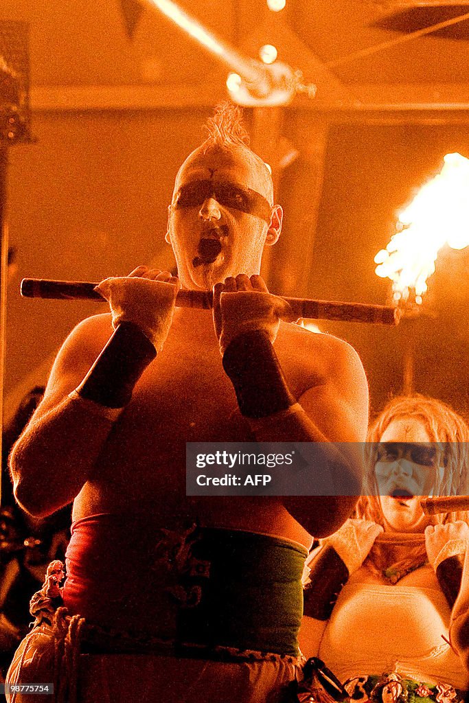 A man holds a torch as he performs durin