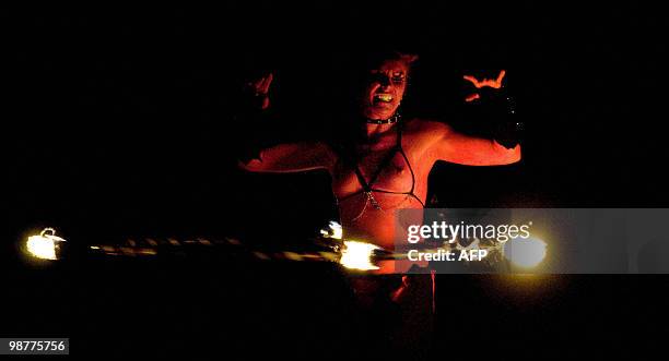 Woman dances with a torch as she performs in the Beltane Fire Festival in Edinburgh, on April 30, 2010. The event, which celebrates an ancient Celtic...