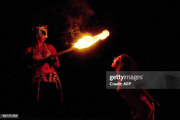 Woman blows on a torch during the Beltane Fire Festival in Edinburgh, on April 30, 2010. The event, which celebrates an ancient Celtic festival, is a...