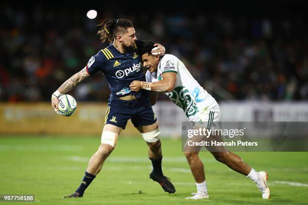 During the round 17: Elliot Dixon of the Highlanders looks to offload the ball during the Super Rugby match between the Highlanders and the Chiefs at...