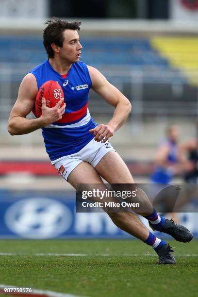 Lachlan Smith of Footscray runs with the ball during the round 13 VFL match between the Northern Blues and the Footscray Bulldogs at Ikon Park on...