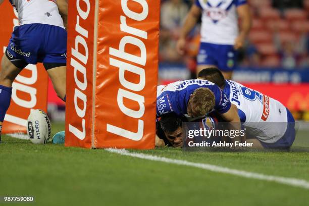 Herman Ese'ese of the Knights scores a try during the round 16 NRL match between the Newcastle Knights and the Canterbury Bulldogs at McDonald Jones...