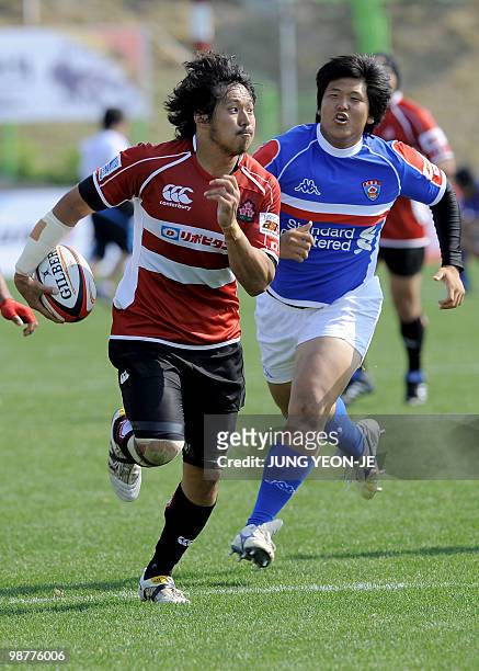 Japan's Kosuke Endo runs with the ball against South Korea during their match of the Asian Five Nations and Rugby World Cup Asian Qualifiers in...