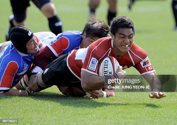 Japan's Touetsu Taufa is tackled by South Korea's Jeon Chi-Do during their match of the Asian Five Nations and Rugby World Cup Asian Qualifiers in...