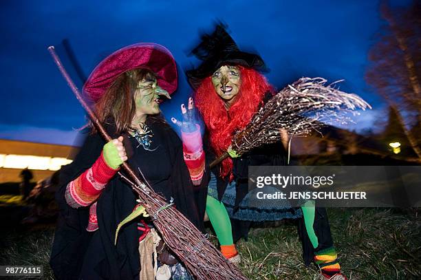 Two Walpurgisnacht enthousiasts dressed as witches dance on late April 30, 2010 at the Brocken mountain near Schierke, eastern Germany. In the...