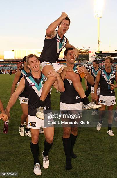 Steven Salopek gets chaired off by Brett Ebert and Troy Chaplin of the Power during the round six AFL match between the Adelaide Crows and the Port...