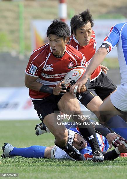 Japan's Yasunori Nagatomo runs with ball against South Korea during their match of the Asian Five Nations and Rugby World Cup Asian Qualifiers in...